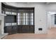 Custom built-in cabinetry with glass shelving and accent lighting adds elegance and functionality to the living space at 4927 Slaton Drive, Acworth, GA 30101