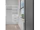 Organized closet features shelving, drawers, and a window with a beautiful outdoor view at 4927 Slaton Drive, Acworth, GA 30101