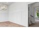 Bright dining area with modern chandelier, wall paneling, and hardwood floors offers a sophisticated ambiance at 4927 Slaton Drive, Acworth, GA 30101