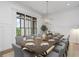 Formal dining room features large window, modern chandelier, and seating for ten, ideal for entertaining at 4927 Slaton Drive, Acworth, GA 30101