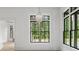 Bright dining room with a modern chandelier and large windows overlooking lush greenery at 4927 Slaton Drive, Acworth, GA 30101