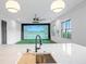 Entertainment room featuring a golf simulator with views from large black-framed windows at 4927 Slaton Drive, Acworth, GA 30101