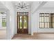 Elegant entryway showcases a glass double door and views of lush greenery, enhancing the home's charm at 4927 Slaton Drive, Acworth, GA 30101
