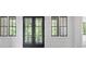 Home exterior shows symmetrical facade with black frame windows and a glass paned entry door at 4927 Slaton Drive, Acworth, GA 30101