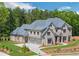 Elegant two-story home featuring stone accents, a gray roof, and a well-maintained front yard at 4927 Slaton Drive, Acworth, GA 30101