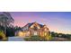 Stunning two-story home with a stone facade, manicured lawn, and a three car garage at 4927 Slaton Drive, Acworth, GA 30101