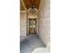Inviting front entry features a wood ceiling, lantern lighting, and brick exterior for an upscale aesthetic at 4927 Slaton Drive, Acworth, GA 30101