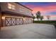 A large garage and driveway leads to a house against a beautiful sunset sky at 4927 Slaton Drive, Acworth, GA 30101