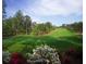 Beautiful golf course view with lush greenery, trees, and colorful flowers in the foreground at 4927 Slaton Drive, Acworth, GA 30101
