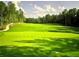Well-manicured golf course with lush green fairways, mature trees, and a flag marking the hole at 4927 Slaton Drive, Acworth, GA 30101