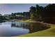 Scenic golf course featuring a tranquil lake, a wooden bridge, and lush green landscapes at 4927 Slaton Drive, Acworth, GA 30101