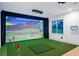 Bright golf simulator room featuring putting green, projector and large screen at 4927 Slaton Drive, Acworth, GA 30101