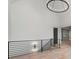Hallway with wood floors, metal railing, and a view of an adjacent room at 4927 Slaton Drive, Acworth, GA 30101