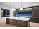 A modern kitchen island with quartz countertop, custom cabinets and blue ambient lighting at 4927 Slaton Drive, Acworth, GA 30101