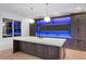 A modern kitchen island with quartz countertop, custom cabinets and blue ambient lighting at 4927 Slaton Drive, Acworth, GA 30101