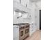 Gourmet kitchen boasts white cabinets and a stainless steel range with pot filler at 4927 Slaton Drive, Acworth, GA 30101