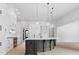 Bright, open kitchen with white cabinets, a dark gray island, and stainless steel appliances at 4927 Slaton Drive, Acworth, GA 30101