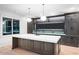 A modern kitchen island with quartz countertop, custom cabinets and black hardware at 4927 Slaton Drive, Acworth, GA 30101