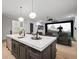 Bright kitchen featuring a large island, quartz countertops, and an adjacent screening room at 4927 Slaton Drive, Acworth, GA 30101