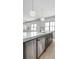 Modern kitchen island with stainless steel dishwasher and sink overlooking the open living space at 4927 Slaton Drive, Acworth, GA 30101