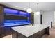 Spacious kitchen with large island and dark wood cabinets, with modern pendant lighting and blue LEDs at 4927 Slaton Drive, Acworth, GA 30101