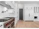 A gourmet kitchen with stainless steel appliances, white cabinets, and hardwood floors at 4927 Slaton Drive, Acworth, GA 30101