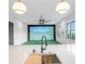 A wet bar with custom cabinets, stainless steel appliances and stone countertops adjacent to a recreation room at 4927 Slaton Drive, Acworth, GA 30101