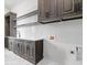Well-appointed laundry room with shaker cabinets, quartz countertops, and white subway tile backsplash at 4927 Slaton Drive, Acworth, GA 30101