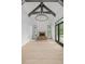 A bright living room featuring a fireplace, wooden ceiling beams, and hardwood floors at 4927 Slaton Drive, Acworth, GA 30101