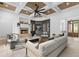 Inviting living room with modern decor, stone fireplace, and coffered ceiling is perfect for relaxing and entertaining at 4927 Slaton Drive, Acworth, GA 30101