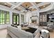 Cozy living room boasts a stone fireplace, custom cabinetry, and large windows for natural light and outdoor views at 4927 Slaton Drive, Acworth, GA 30101