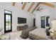 Stunning main bedroom showcasing vaulted ceilings with wood beams and a private exterior door at 4927 Slaton Drive, Acworth, GA 30101