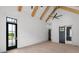 Bright main bedroom showcasing vaulted ceilings with wood beams and a private exterior door at 4927 Slaton Drive, Acworth, GA 30101