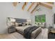Luxurious main bedroom featuring vaulted ceilings with wood beams and a private exterior door at 4927 Slaton Drive, Acworth, GA 30101