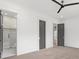 Main bedroom with gray doors, a ceiling fan, and doorways to the main bathroom and other areas of the home at 4927 Slaton Drive, Acworth, GA 30101