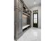 Elegant mudroom featuring custom cabinets, seating with storage, and stylish herringbone flooring at 4927 Slaton Drive, Acworth, GA 30101