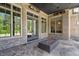 Covered outdoor patio featuring a brick fireplace and stone flooring at 4927 Slaton Drive, Acworth, GA 30101