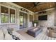 Inviting covered patio with a fireplace, ceiling fan, wood ceiling, brick walls and comfortable seating at 4927 Slaton Drive, Acworth, GA 30101