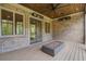 Outdoor patio with a fire pit, ceiling fan, brick wall, and wood flooring that creates a cozy ambiance at 4927 Slaton Drive, Acworth, GA 30101