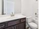 Bathroom vanity with granite countertop and a toilet next to a tub and shower combo at 5391 Heron Bay Blvd, Locust Grove, GA 30248