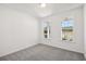 Bright bedroom featuring carpet flooring and natural light from two windows at 5391 Heron Bay Blvd, Locust Grove, GA 30248