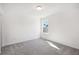 Bedroom features plush carpet and one window with view of the backyard at 5391 Heron Bay Blvd, Locust Grove, GA 30248