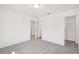 Bedroom featuring neutral carpet, white walls, and two open doorways that lead to other rooms at 5391 Heron Bay Blvd, Locust Grove, GA 30248