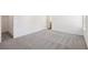 Neutral carpeted bedroom with a white door and trim at 5391 Heron Bay Blvd, Locust Grove, GA 30248