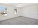 Bright bedroom with two windows providing natural light and a neutral-toned carpet at 5391 Heron Bay Blvd, Locust Grove, GA 30248