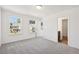 Bedroom features plush carpet and two windows with views of the neighborhood at 5391 Heron Bay Blvd, Locust Grove, GA 30248