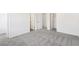 Bedroom with plush carpet and multiple white doors, including access to closets at 5391 Heron Bay Blvd, Locust Grove, GA 30248