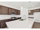 Stylish kitchen with stainless steel appliances, granite counters and pendant lights at 5391 Heron Bay Blvd, Locust Grove, GA 30248