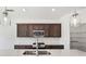 Close-up of a kitchen island with stainless appliances and modern pendant lighting at 5391 Heron Bay Blvd, Locust Grove, GA 30248