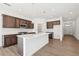 An open-concept kitchen with an island, stainless appliances, and modern design at 5391 Heron Bay Blvd, Locust Grove, GA 30248